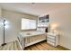 Inviting bedroom with a queen bed, contemporary lamp, side table and stylish wood-look flooring at 864 E Eldorado Ln, Las Vegas, NV 89123