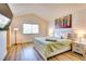 Cozy bedroom with natural light, modern decor, and wood-look flooring at 864 E Eldorado Ln, Las Vegas, NV 89123