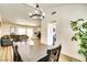 Dining room with modern light fixture with view of bright living room and updated kitchen at 864 E Eldorado Ln, Las Vegas, NV 89123