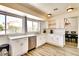 Updated kitchen with white cabinetry, stainless steel dishwasher, and a view of the dining area at 864 E Eldorado Ln, Las Vegas, NV 89123