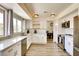 Bright, updated kitchen featuring white cabinets, stainless steel appliances, and wood-look flooring at 864 E Eldorado Ln, Las Vegas, NV 89123