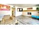 Open living room with a brick fireplace, a large television, and modern decor at 864 E Eldorado Ln, Las Vegas, NV 89123