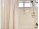 Bright bathroom shower with modern shower head and storage shelf, complemented by a shower curtain at 864 E Eldorado Ln, Las Vegas, NV 89123