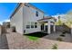 A backyard view highlights the patio, small grass patch, and gravel landscaping surrounding the home's exterior at 8786 Sand Verbena Ave, Las Vegas, NV 89117
