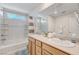 Bright bathroom featuring double sink vanity, shower over tub and a neutral color palette at 8786 Sand Verbena Ave, Las Vegas, NV 89117