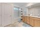 Bright bathroom featuring double sinks, and a shower-tub combo, providing style and functionality at 8786 Sand Verbena Ave, Las Vegas, NV 89117