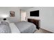 Cozy bedroom featuring carpeted floors, neutral color palette and entertainment center with wall-mounted TV at 8786 Sand Verbena Ave, Las Vegas, NV 89117