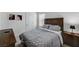 Comfortable bedroom featuring carpeted floors, neutral color palette, and a bed with patterned bedding at 8786 Sand Verbena Ave, Las Vegas, NV 89117