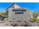 Stone community sign reading Whistling Sands surrounded by desert landscaping at 8786 Sand Verbena Ave, Las Vegas, NV 89117