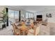 Bright dining area features an elegant wood table and access to a backyard sliding door at 8786 Sand Verbena Ave, Las Vegas, NV 89117