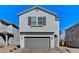 Charming two-story home with a gray exterior, a two-car garage, and a beautifully landscaped front yard at 8786 Sand Verbena Ave, Las Vegas, NV 89117