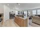 Stylish kitchen with stainless steel appliances and granite island that opens to dining and living areas at 8786 Sand Verbena Ave, Las Vegas, NV 89117