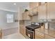 Well-lit kitchen with stainless appliances, granite counters and backsplash, opening to living area at 8786 Sand Verbena Ave, Las Vegas, NV 89117