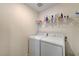 Functional laundry room with modern washer and dryer, featuring shelving for convenient storage and organization at 8786 Sand Verbena Ave, Las Vegas, NV 89117