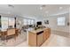 Bright, open living space with a kitchen island, dining table, and comfortable seating area at 8786 Sand Verbena Ave, Las Vegas, NV 89117