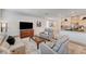 Cozy living room with neutral décor, plush seating, and an open layout with an eat-in kitchen at 8786 Sand Verbena Ave, Las Vegas, NV 89117