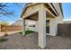 Covered patio area with paved flooring, complemented by a small patch of grass and desert landscaping at 8786 Sand Verbena Ave, Las Vegas, NV 89117