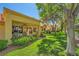 Charming home with a covered patio overlooking a lush green lawn with mature trees and landscaping at 9024 Starmount Dr, Las Vegas, NV 89134
