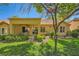 A cozy backyard features a covered patio with comfortable seating, lush lawn, and desert landscaping at 9024 Starmount Dr, Las Vegas, NV 89134