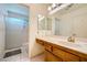 Functional bathroom featuring a vanity with storage, a large mirror, and a glass-enclosed shower at 9024 Starmount Dr, Las Vegas, NV 89134