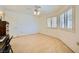 This sunlit bedroom has windows, a ceiling fan and a small desk at 9024 Starmount Dr, Las Vegas, NV 89134