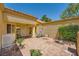 Private courtyard with brick flooring, potted plants, comfortable seating and charming architectural details at 9024 Starmount Dr, Las Vegas, NV 89134