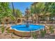 Outdoor space with a tiered fountain surrounded by vibrant flowers and lush greenery at 9024 Starmount Dr, Las Vegas, NV 89134