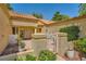 Inviting single-story home featuring a gated courtyard, beautiful landscaping, and a terracotta tile roof at 9024 Starmount Dr, Las Vegas, NV 89134