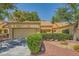 Inviting single-story home featuring a 2-car garage, lush landscaping, and charming curb appeal at 9024 Starmount Dr, Las Vegas, NV 89134