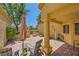 Outdoor patio with shade umbrella, brick flooring, and stylish seating area at 9024 Starmount Dr, Las Vegas, NV 89134