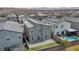 An aerial view of a home and surrounding neighborhood featuring a pool and putting green at 9876 Magnus Ct, Las Vegas, NV 89178