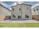 The backyard is fenced and features a large paved area and artificial turf at 9876 Magnus Ct, Las Vegas, NV 89178