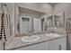 Bathroom featuring double sinks with granite countertop and decorative hand towels at 9876 Magnus Ct, Las Vegas, NV 89178
