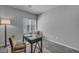 Bedroom featuring neutral walls, grey carpet, window, chair, and stylish black desk at 9876 Magnus Ct, Las Vegas, NV 89178