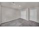 Cozy bedroom shows plush carpeting, a closet with folding doors, and natural light for a comfortable retreat at 9876 Magnus Ct, Las Vegas, NV 89178