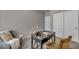 Comfortable room with neutral walls, grey carpet, chair, and stylish black desk with decor at 9876 Magnus Ct, Las Vegas, NV 89178