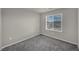 Cozy carpeted bedroom with window showing neighborhood view at 9876 Magnus Ct, Las Vegas, NV 89178
