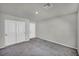 A secondary bedroom featuring neutral carpet, closet, and simple design elements at 9876 Magnus Ct, Las Vegas, NV 89178