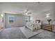 Spacious bedroom with carpet flooring, natural lighting, ceiling fan, and neutral tones at 9876 Magnus Ct, Las Vegas, NV 89178