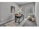 Cozy room with neutral walls, grey carpet, window, chair, and stylish black desk at 9876 Magnus Ct, Las Vegas, NV 89178