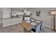 Dining area with table for four, modern decor, and view to open kitchen at 9876 Magnus Ct, Las Vegas, NV 89178