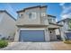 Two-story home featuring a two-car garage and desert landscaping at 9876 Magnus Ct, Las Vegas, NV 89178