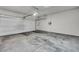 Spacious garage with concrete flooring and an automatic door at 9876 Magnus Ct, Las Vegas, NV 89178