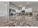 Modern kitchen with granite countertops, white cabinets, stainless steel appliances, and ample counter space at 9876 Magnus Ct, Las Vegas, NV 89178
