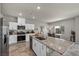 Open kitchen featuring stainless appliances, island with granite countertops, and view to dining area at 9876 Magnus Ct, Las Vegas, NV 89178