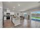 Open kitchen boasts stainless appliances, island with granite countertops, dining area and backyard view at 9876 Magnus Ct, Las Vegas, NV 89178
