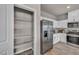 Modern kitchen with white cabinets, stainless steel appliances, and a walk-in pantry for ample storage at 9876 Magnus Ct, Las Vegas, NV 89178