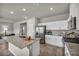 Open kitchen featuring stainless appliances, granite countertops, island and view to dining area at 9876 Magnus Ct, Las Vegas, NV 89178