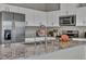 Modern kitchen featuring stainless steel appliances, granite countertops, and white cabinetry at 9876 Magnus Ct, Las Vegas, NV 89178