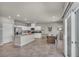 Modern kitchen with stainless steel appliances, granite countertops, island and adjacent dining space at 9876 Magnus Ct, Las Vegas, NV 89178